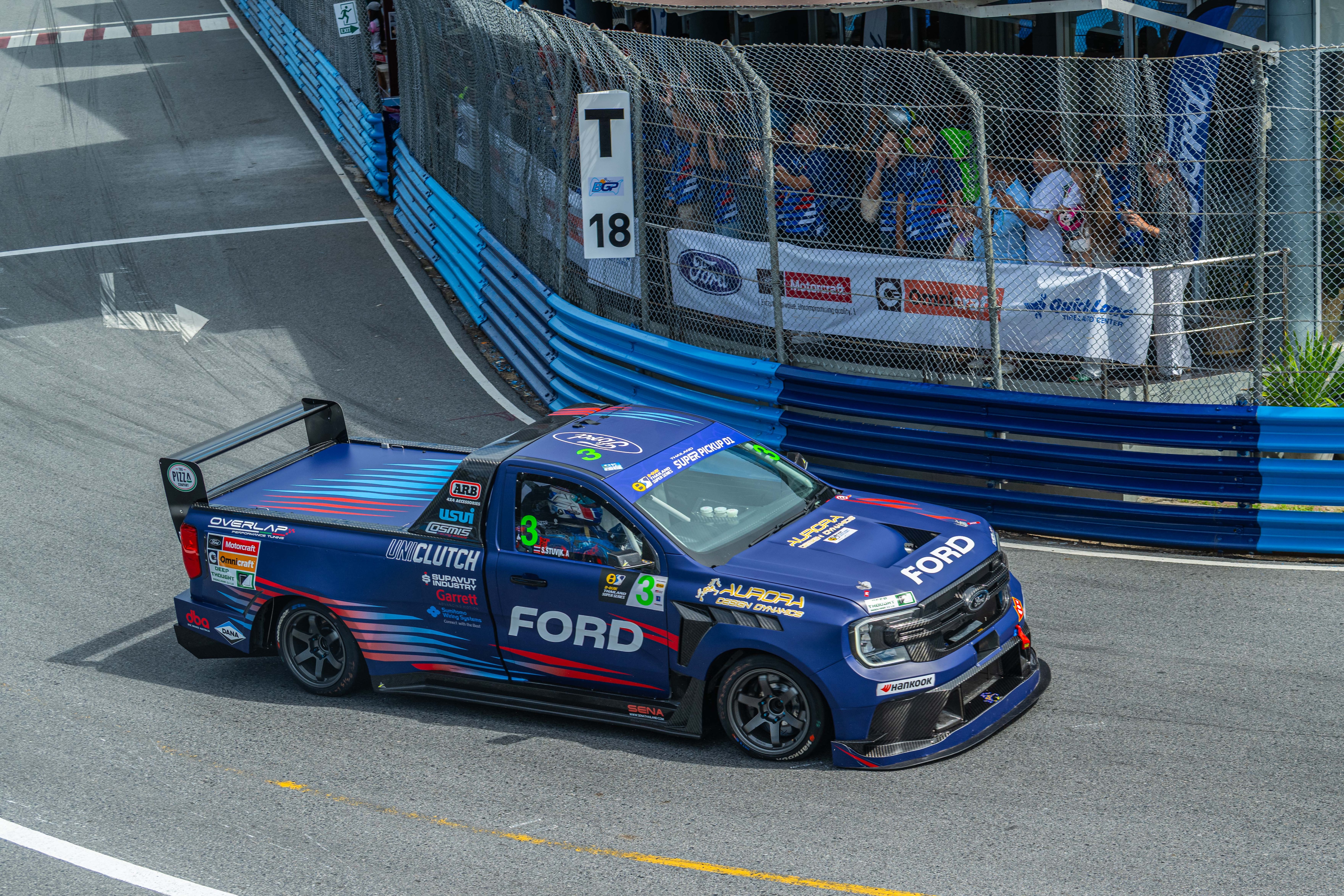 The No. 3 Ford Ranger race truck is captured mid-corner.